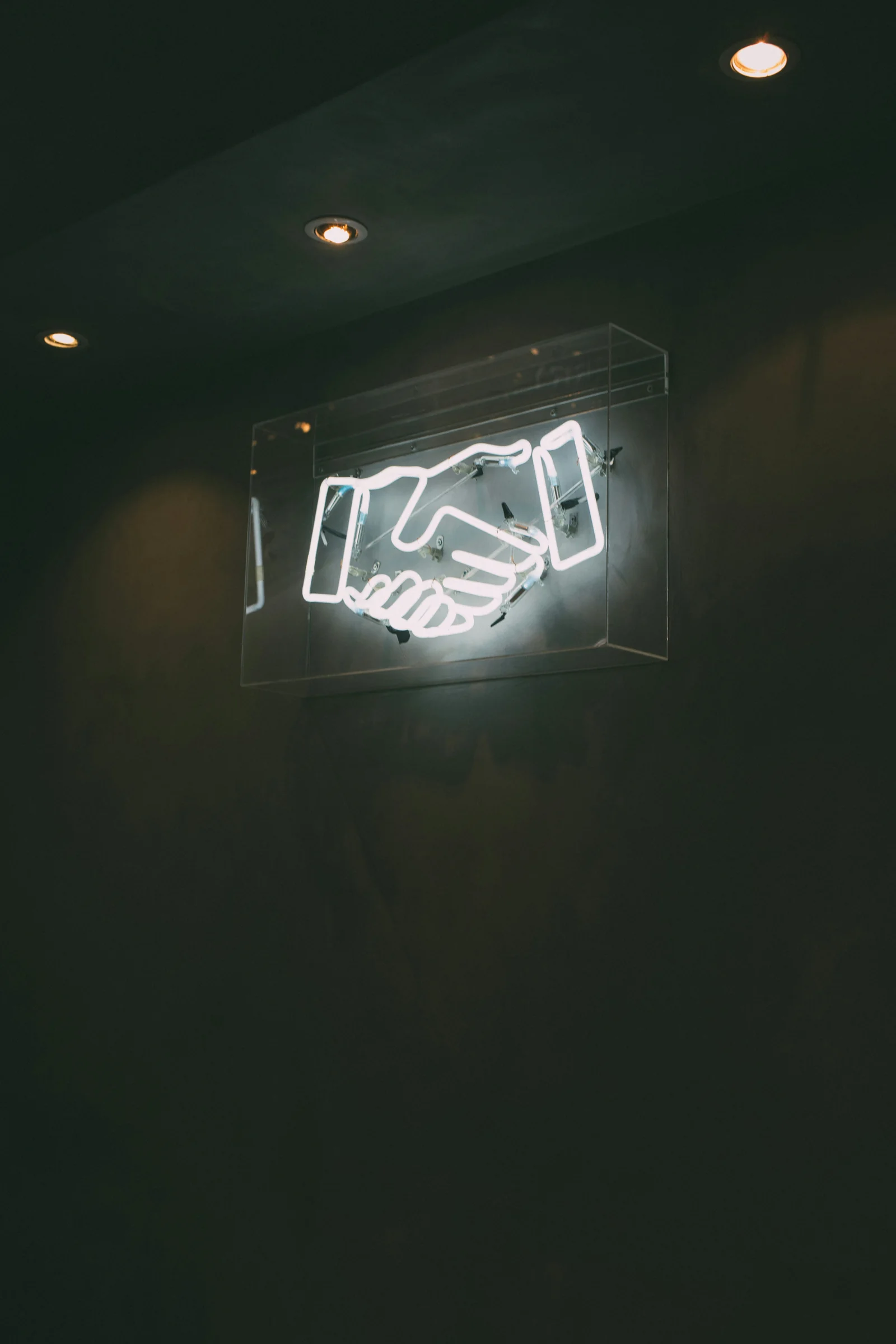 Neon handshake sign representing a representation agreement