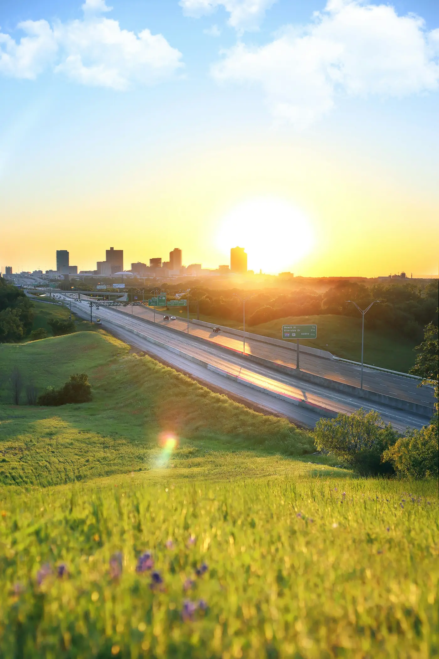 Sunrise over the I-35W corridor leading into the downtown Fort Worth skyline