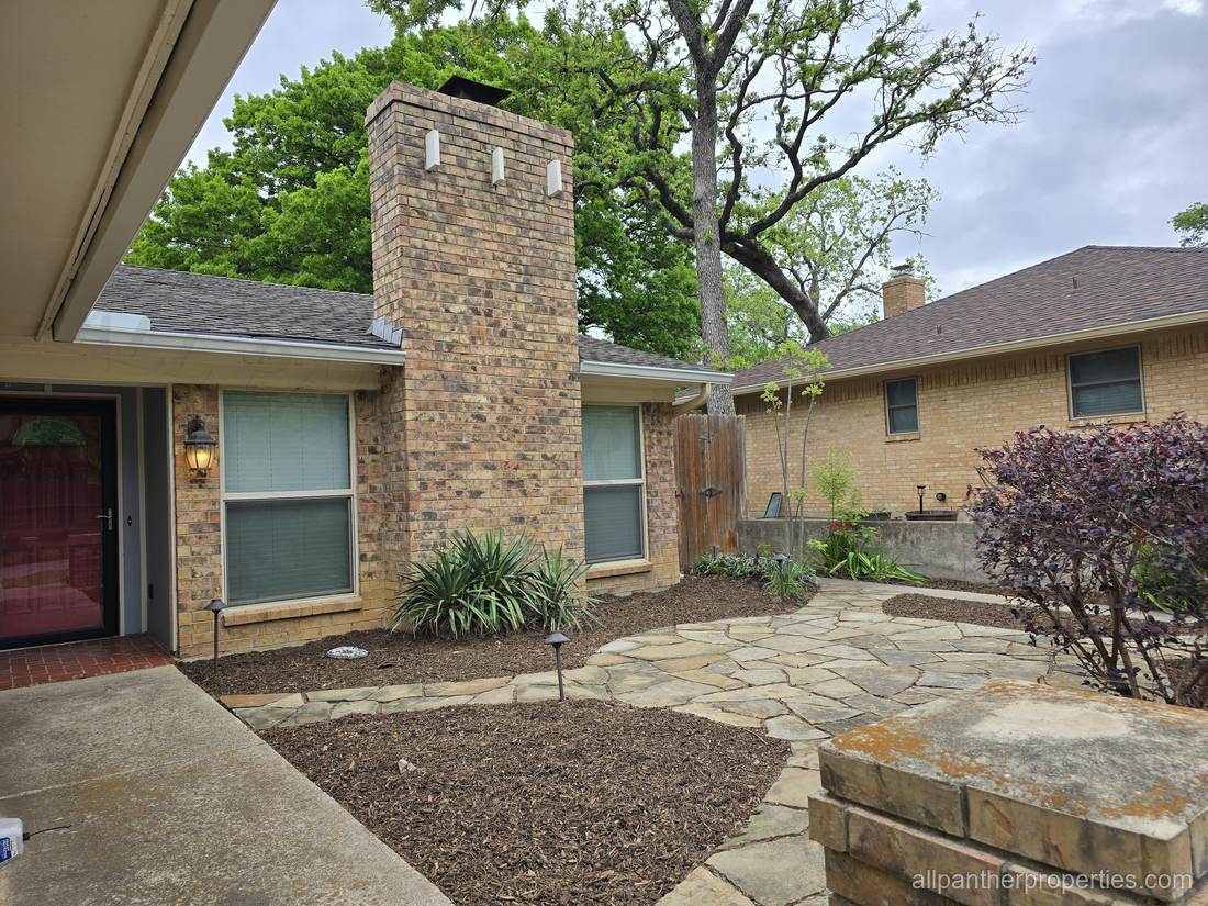 Flagstone courtyard of a home managed by All Panther Properties